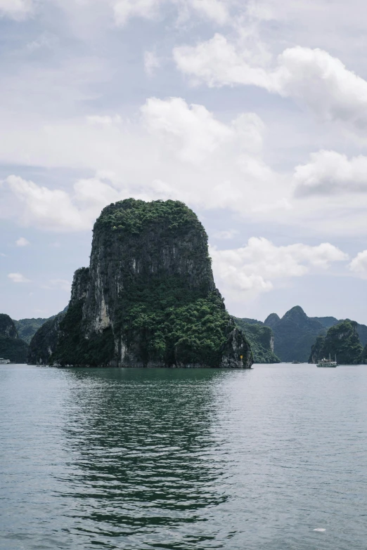 a small island in the middle of a body of water, inspired by Lam Qua, trending on unsplash, limestone, vietnam war, 8k resolution”, tall