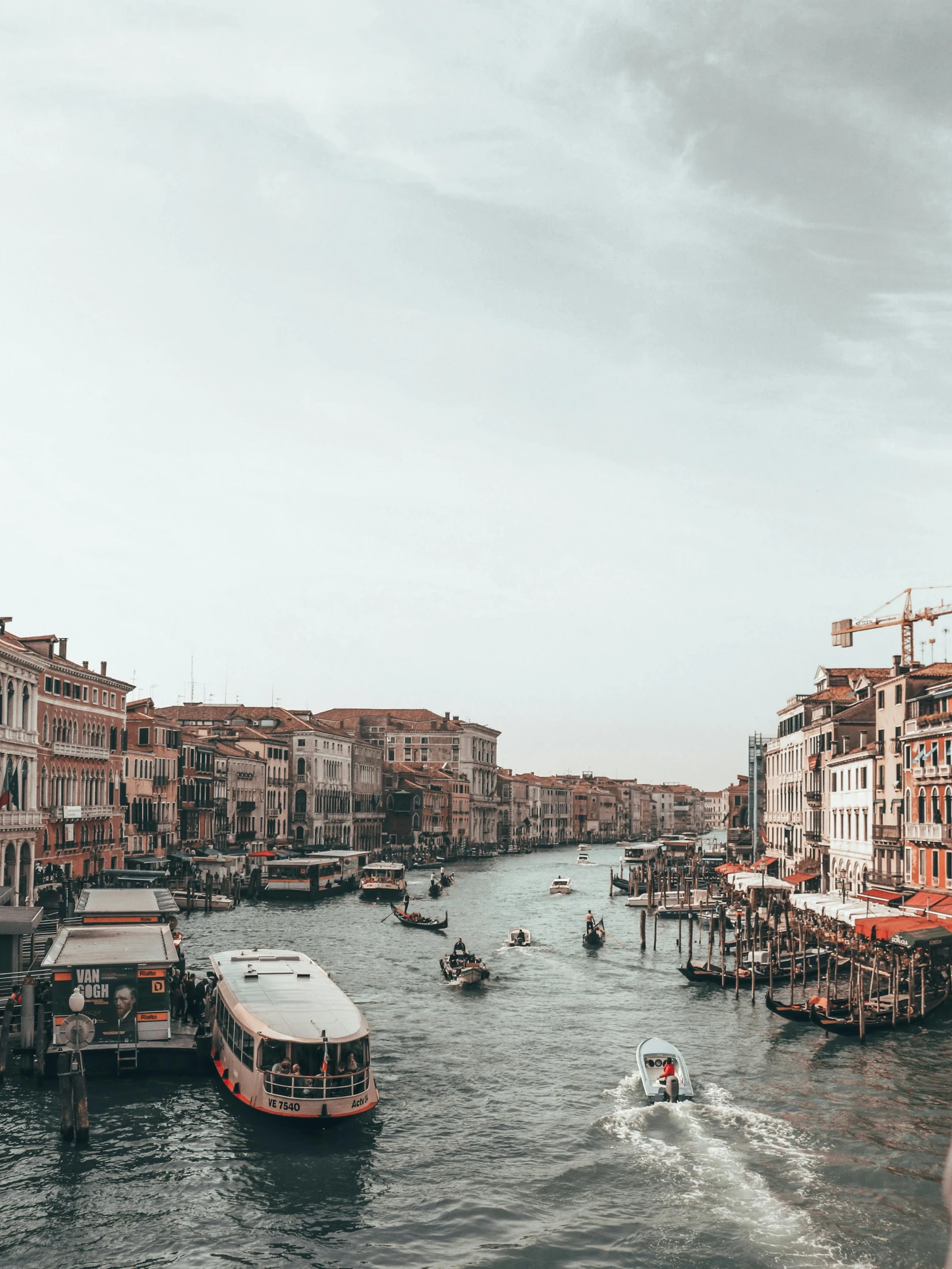 a river filled with lots of boats next to tall buildings, a photo, pexels contest winner, renaissance, burnt sienna and venetian red, 🤬 🤮 💕 🎀, “diamonds, grey