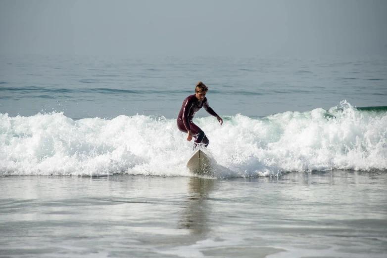 a man riding a wave on top of a surfboard, pexels contest winner, arabesque, hollister ranch, thumbnail, islamic, young female