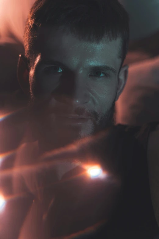 a close up of a person holding a light, by Adam Marczyński, trending on reddit, digital art, male model, mid-shot of a hunky, cinematic footage, staring seductively