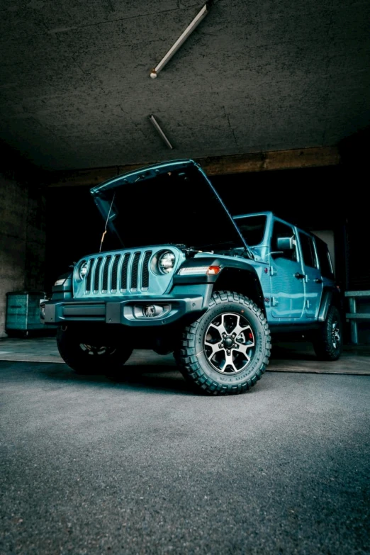 a blue jeep parked in a parking garage, hextech, teal silver red, slim build, high quality photo