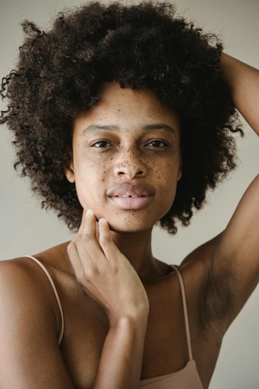 a close up of a woman with freckles on her face, by Cosmo Alexander, trending on pexels, renaissance, afro, perfect body face and hands, woman holding another woman, shaved face