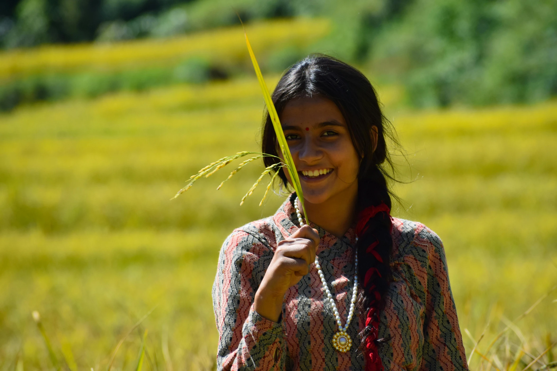 a woman standing in a field holding a plant, pexels contest winner, hurufiyya, young himalayan woman, avatar image, rice, smiley