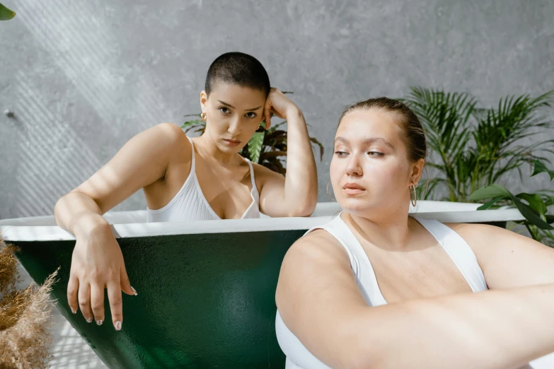 a couple of women sitting in a bath tub, trending on pexels, morbidly obese, charli bowater and artgeem, pouty, attractive photo