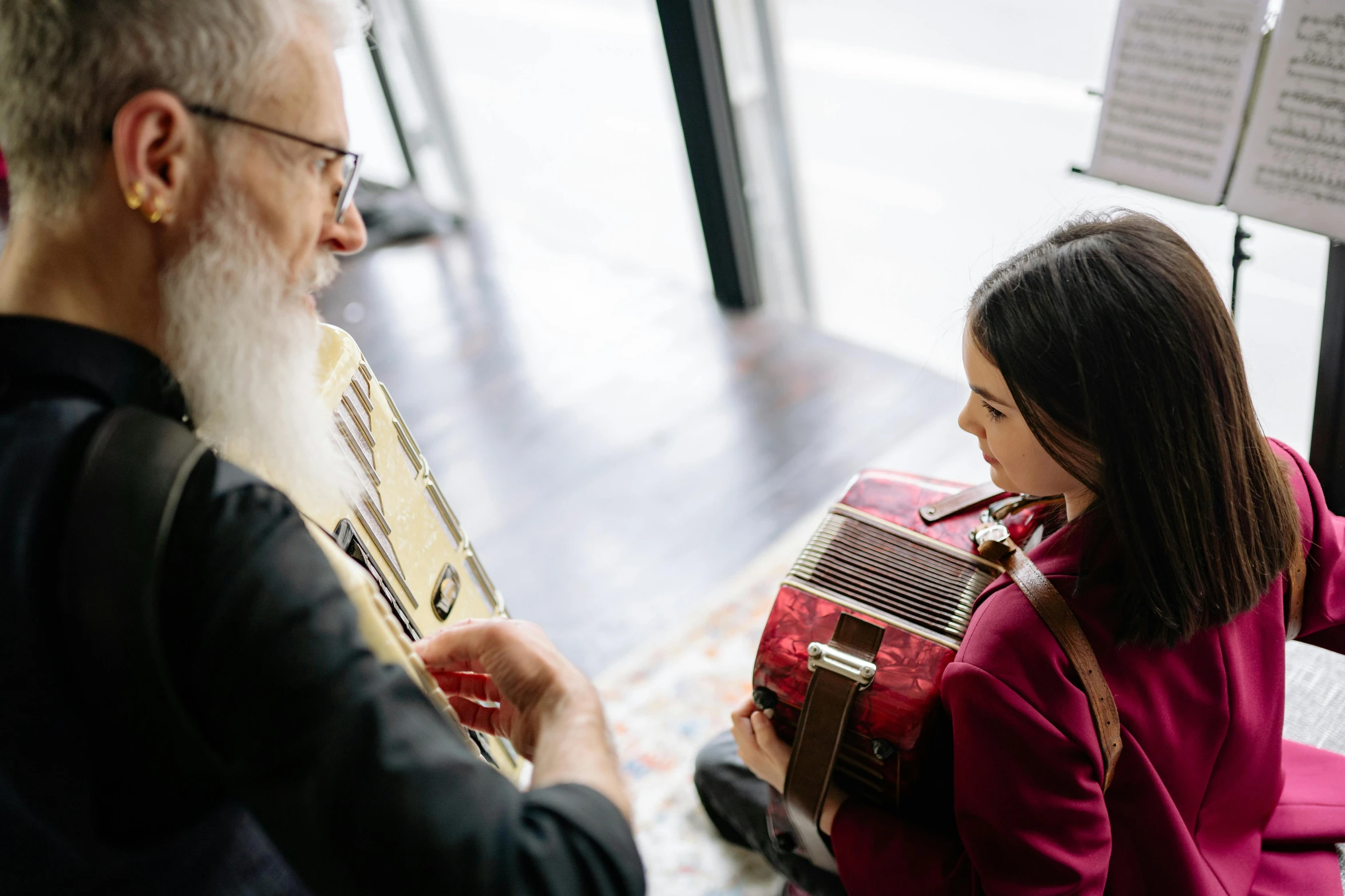 a man and a woman playing a musical instrument, an album cover, by Konrad Witz, pexels contest winner, old gigachad with grey beard, with a kid, australian, looking from side