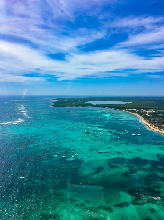 a large body of water next to a beach, by Robbie Trevino, pexels contest winner, hurufiyya, airplane view, carribean turquoise water, thumbnail, multiple stories