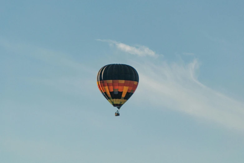 a hot air balloon flying through a blue sky, pexels contest winner, arabesque, slight overcast, from wheaton illinois, crepuscular, brown
