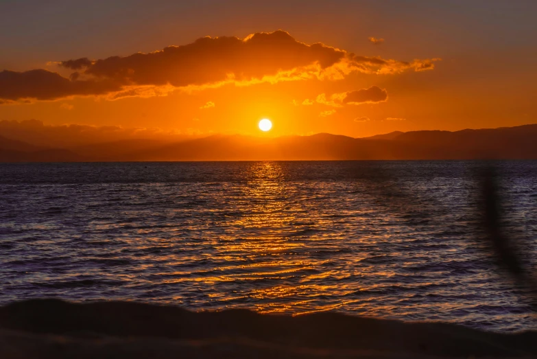 the sun is setting over a body of water, by Robbie Trevino, pexels contest winner, abel tasman, yellow, maui, winter sun