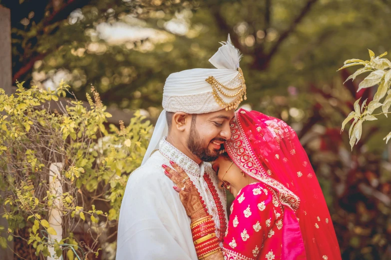 a man and woman standing next to each other, pexels contest winner, hurufiyya, indian style, thumbnail, groom, embracing