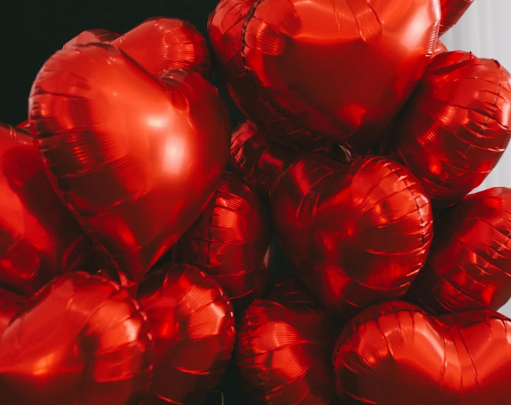 a bunch of red heart shaped balloons, by Julia Pishtar, pexels contest winner, metallic, thumbnail, jen atkin, gifts
