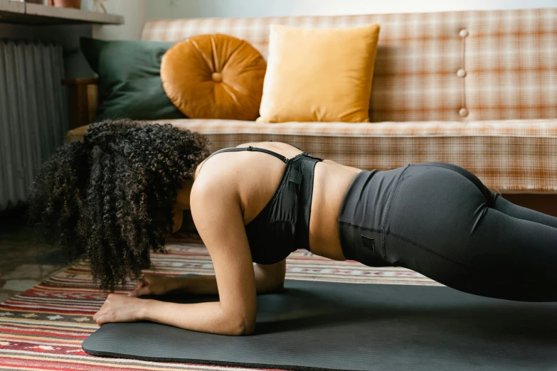 a woman is doing an exercise on a yoga mat, trending on pexels, arabesque, relaxing on the couch, veins popping out, thumbnail, profile image