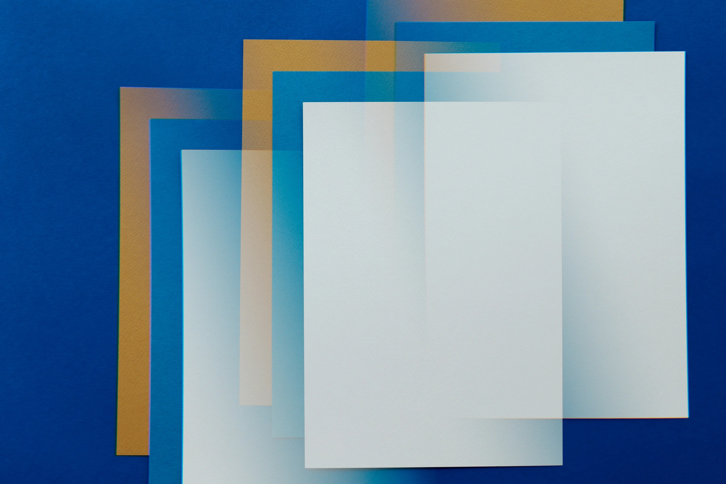 a close up of a piece of paper on a blue surface, by Jan Rustem, lyrical abstraction, gradient orange, white panels, group photo, square shapes