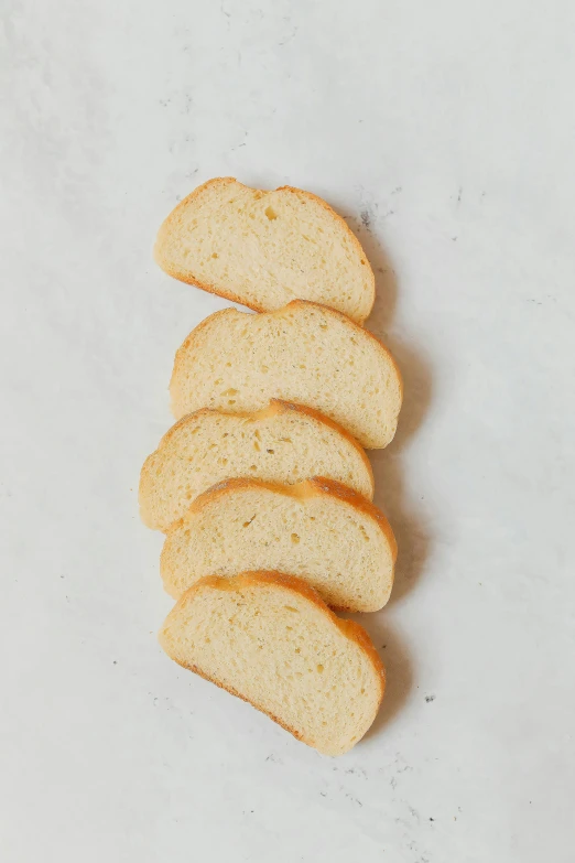 a close up of slices of bread on a table, ivory, rounded face, petite, french nouveau