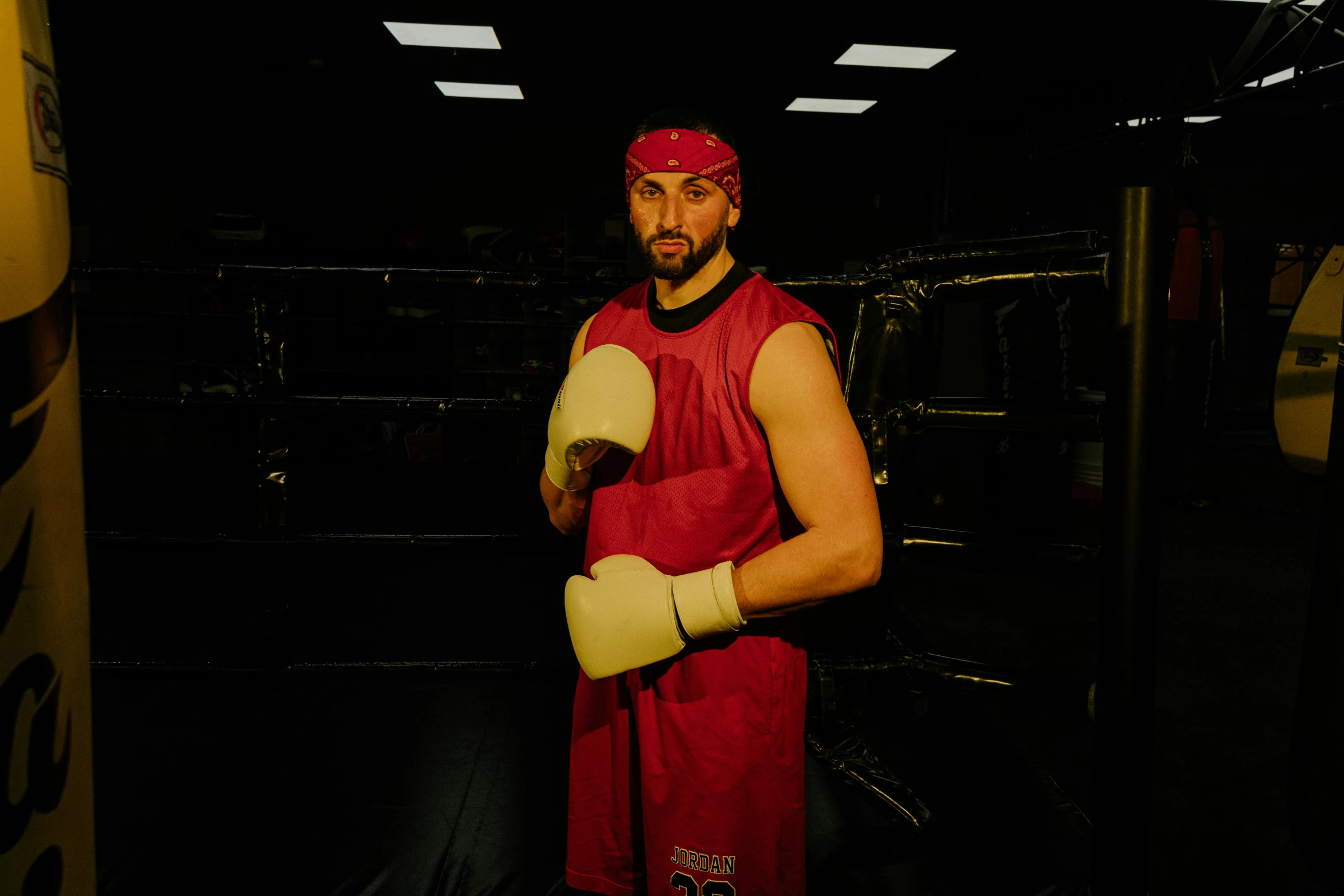 a man standing in the middle of a boxing ring, a portrait, inspired by Volkan Baga, pexels contest winner, renaissance, wearing red and yellow hero suit, rugged man portrait, ray william johnson, press shot