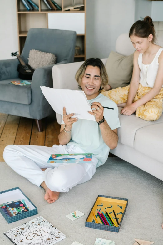 a couple of people that are sitting on the floor, a child's drawing, pexels contest winner, cool dad vibes, he is holding a large book, colouring pages, asian male