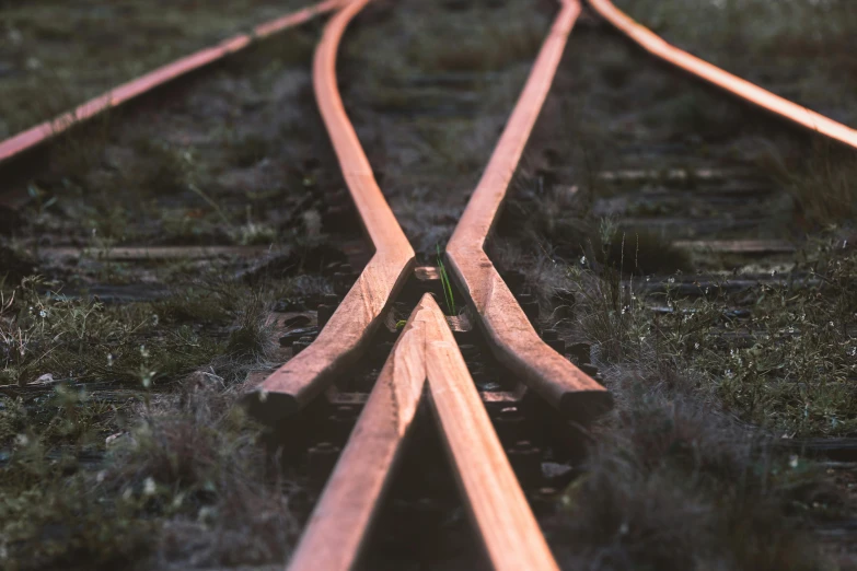 a couple of train tracks next to each other, an album cover, by Filip Hodas, pexels contest winner, copper, crossing the line, middle close up shot, very elongated lines