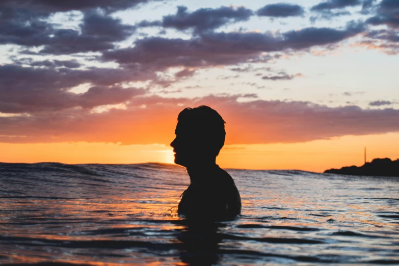 a man standing in the ocean at sunset, unsplash contest winner, renaissance, profile image, avatar image, outlined silhouettes, swimming