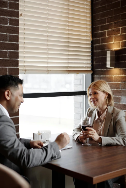 a couple of people that are sitting at a table, woman in business suit, paul barson, lachlan bailey, romance