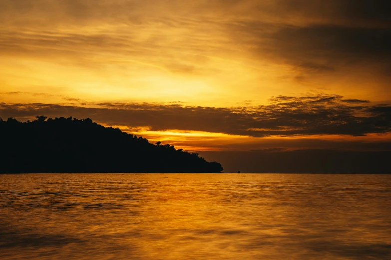 the sun is setting over a body of water, pexels contest winner, sumatraism, shades of yellow, thumbnail, manly, gold