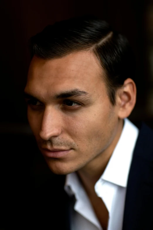 a close up of a person wearing a suit and tie, antipodeans, a young man, raffael, side profile centered portrait, photographed for reuters