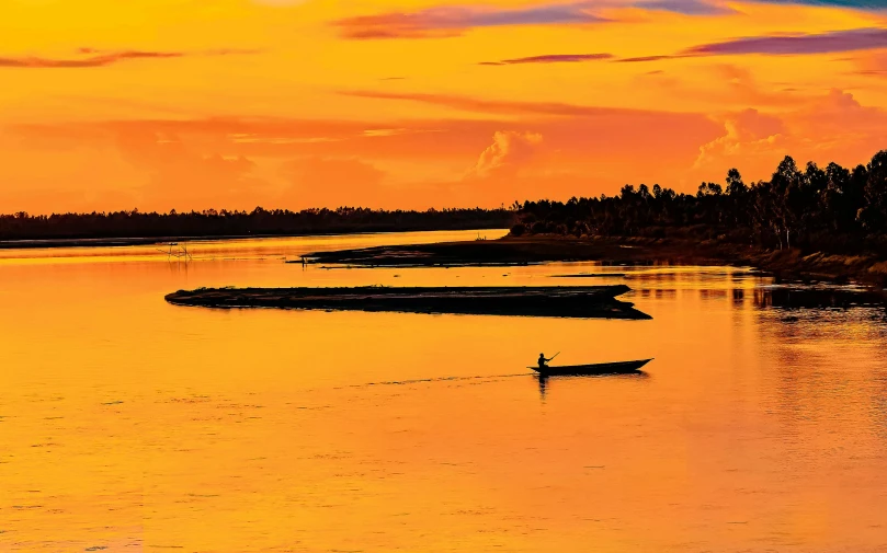 a person in a boat on a body of water, by Peter Churcher, pexels contest winner, sumatraism, orange skies, great river, fine art print, cambodia