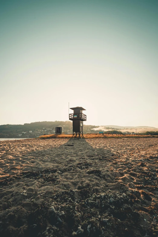 a lifeguard tower sitting on top of a sandy beach, by Niko Henrichon, unsplash, renaissance, square, brown, standing on a hill, late afternoon