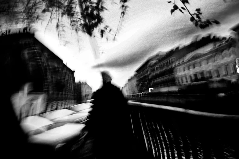 a blurry photo of a person walking down a street, by Zsolt Bodoni, digital art, sergey krasovskiy, river, by joseph binder, black and white image