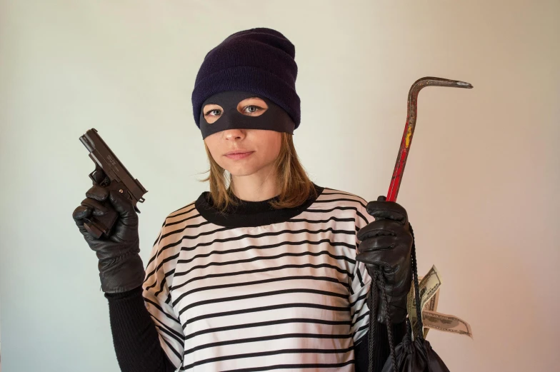 a woman wearing a mask and holding a gun, by Helen Stevenson, pexels, renaissance, where's wally, kevin mitnick as a bank robber, sydney sweeney, halloween