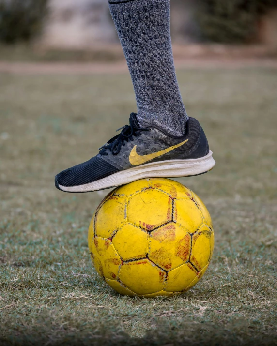 a person standing on top of a soccer ball, profile image, upclose, on the ground, square