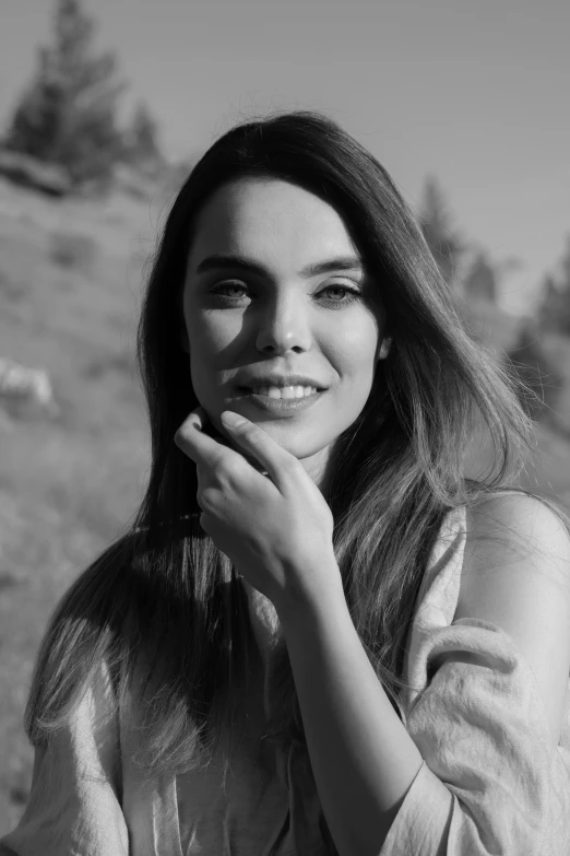 a black and white photo of a woman with long hair, pexels contest winner, dressed anya taylor - joy, sunny day time, meni chatzipanagiotou, smiling sweetly