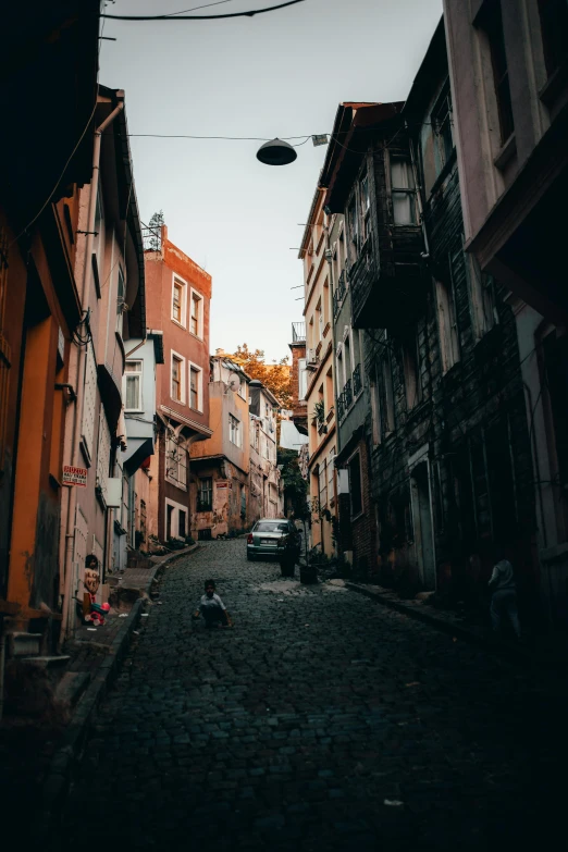 a narrow cobblestone street in an old european city, a picture, pexels contest winner, fallout style istanbul, hills, brown, square