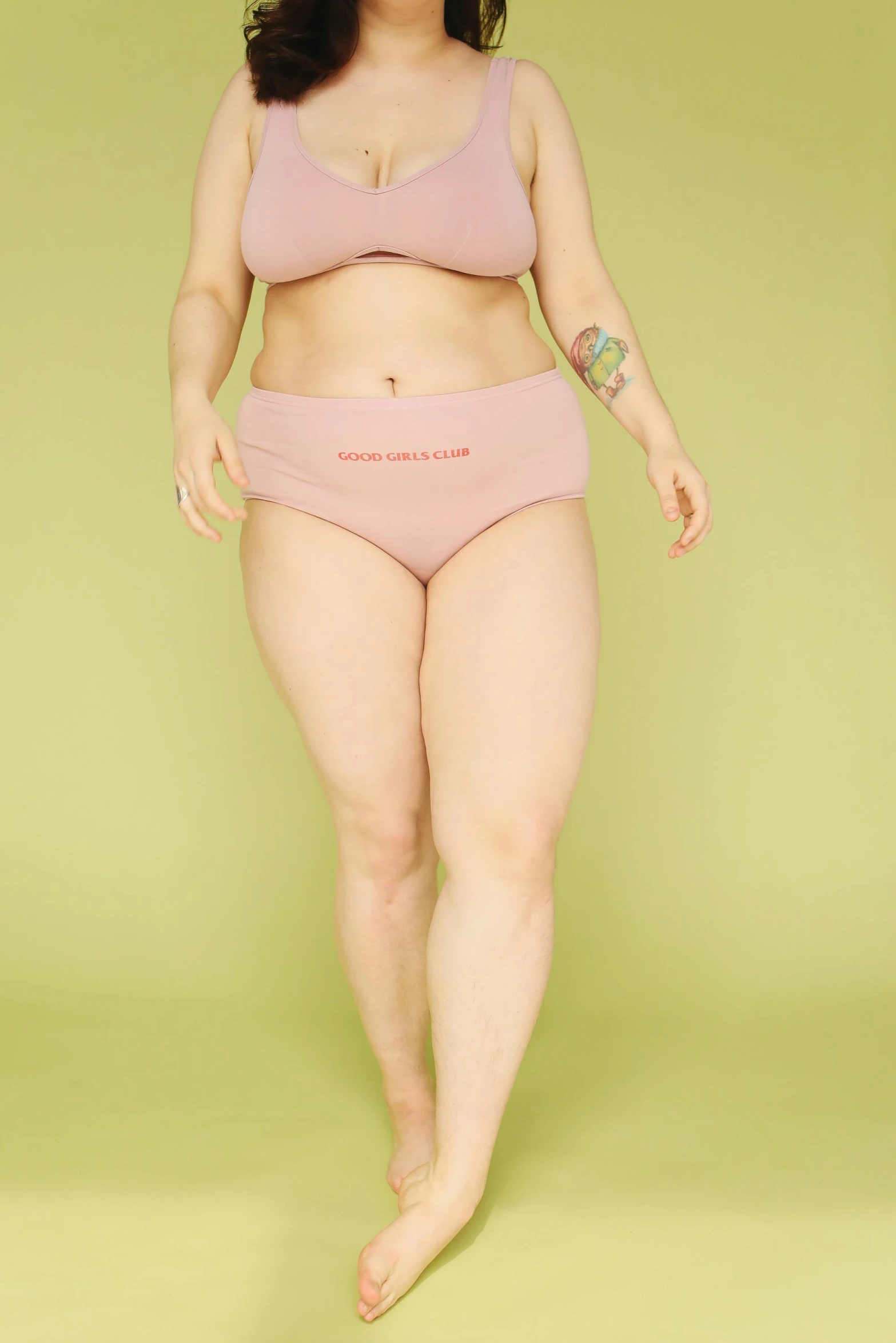 a woman in pink underwear standing in front of a green background, inspired by Vanessa Beecroft, unsplash, overweight, on a pale background, ((pink)), round-cropped
