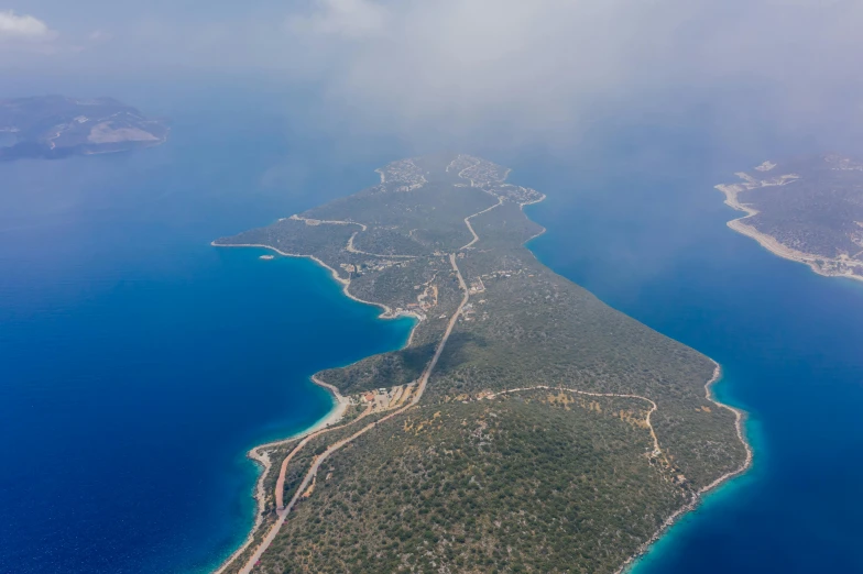 an aerial view of an island in the middle of the ocean, by Exekias, pexels contest winner, hurufiyya, road to the sea, 2 0 0 0's photo, high quality product image”, turkey