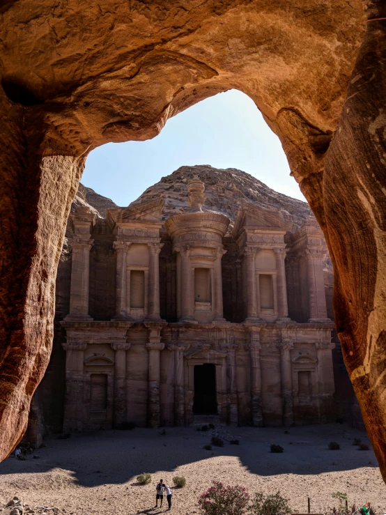 a couple of people that are standing in front of a building, pexels contest winner, baroque, ancient ruins under the desert, inside the tomb of jesus, inside of an expansive cave, an arab standing watching over