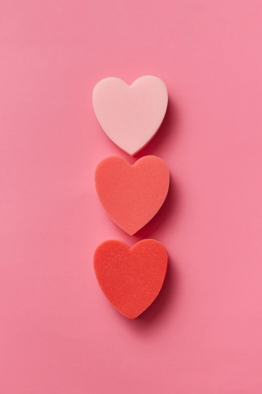 three hearts on a pink background, by Carey Morris, trending on pexels, sephora, foam, on grey background, blender