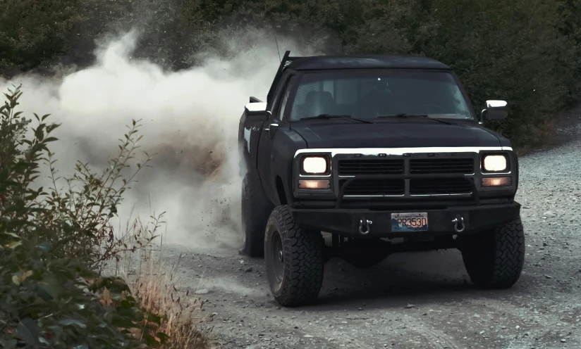 a black truck driving down a dirt road, an album cover, unsplash, soft color dodge, smoke, hyper realism 8k, modded