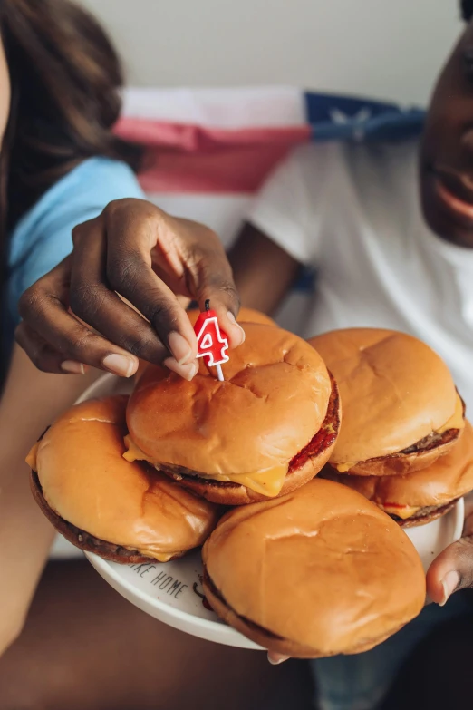 a close up of a person holding a plate of hamburgers, kids, 4th of july, uganda knuckles, 4l