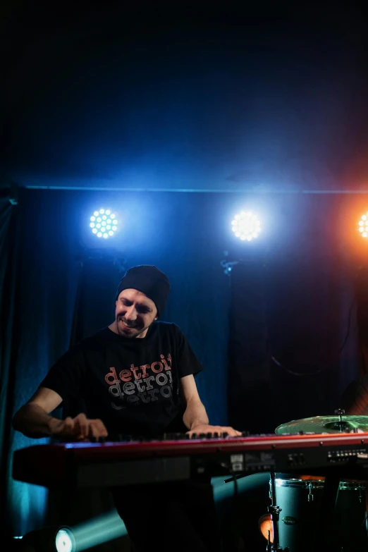 a man that is sitting in front of a keyboard, by Doug Ohlson, stage at a club, edin durmisevic, kyle hotz, high quality photo