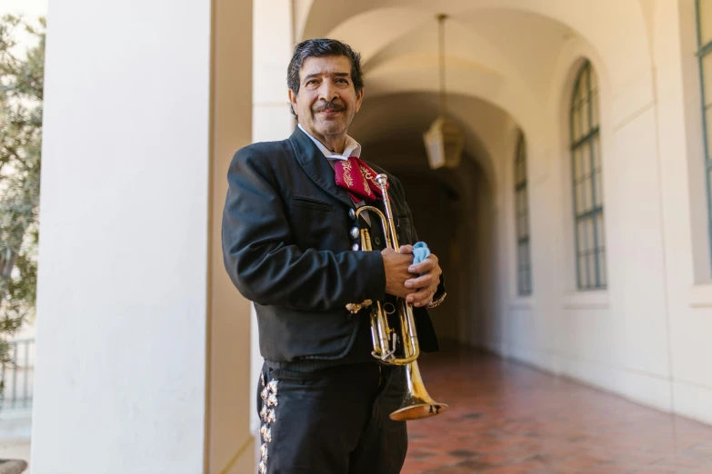 a man in a suit holding a trumpet, by Alejandro Obregón, while smiling for a photograph, julia fuentes, exploration, inside a grand