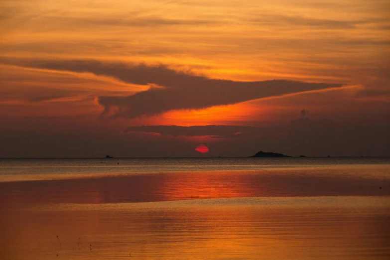 a large body of water with a sunset in the background, by Jan Tengnagel, pexels contest winner, islands on horizon, orange hue, slide show, grey