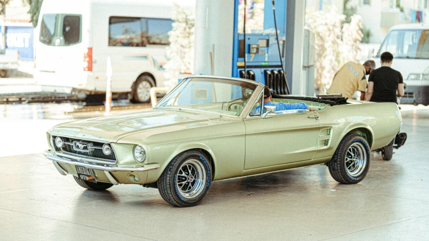 a car that is sitting in a garage, a colorized photo, pexels contest winner, photorealism, green 1967 ford mustang gt, soft top, australian, liquid gold