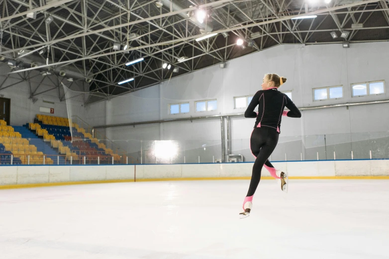 a woman is skating on an ice rink, shutterstock, arabesque, in a gym, running, neoprene, backfacing