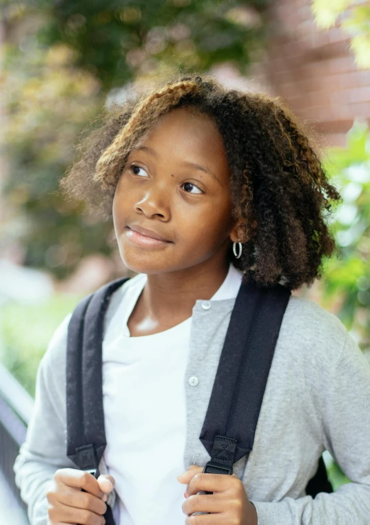 a close up of a person with a backpack, youthful taliyah, mid length portrait photograph, multiple stories, schools