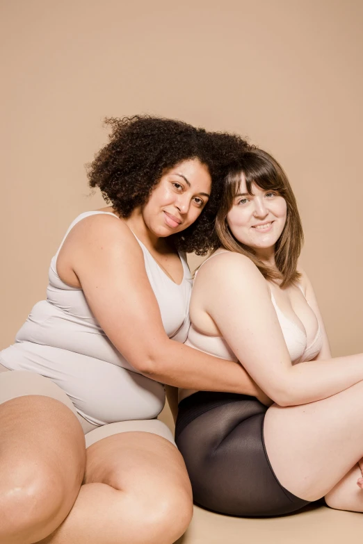 a couple of women sitting next to each other, thick body, promo image, skin color, half - body composition