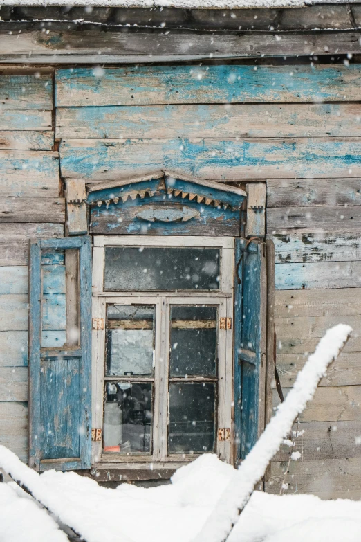 a wooden building with a window covered in snow, inspired by Isaac Levitan, pexels contest winner, renaissance, distressed paint, blue and grey, brown, arctic