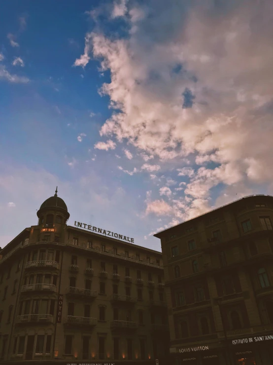 a tall building with a clock on top of it, an album cover, unsplash contest winner, renaissance, naples, evening sky, trending on vsco, swiss architecture