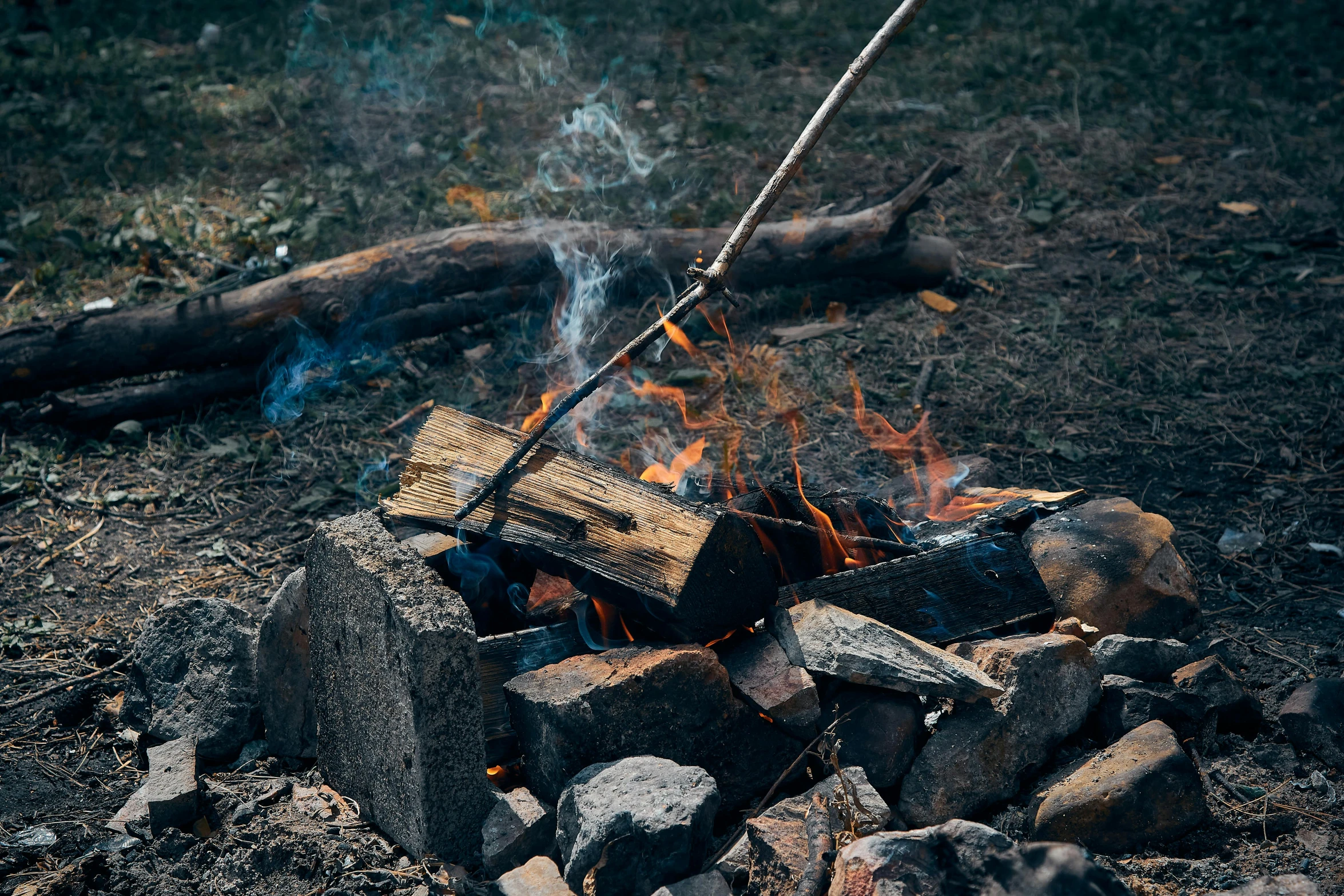 a campfire with a stick sticking out of it, by Elsa Bleda, pexels contest winner, thumbnail, multiple stories, barbecue, rectangle