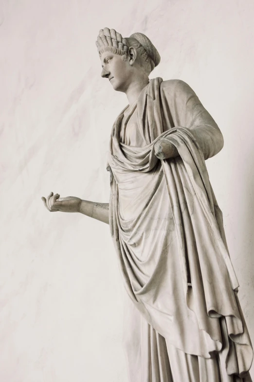 a black and white photo of a statue of a woman, a statue, inspired by Augustus Dunbier, pexels, dressed in roman clothes, teenage boy, white marble interior photograph, wearing an old tunic