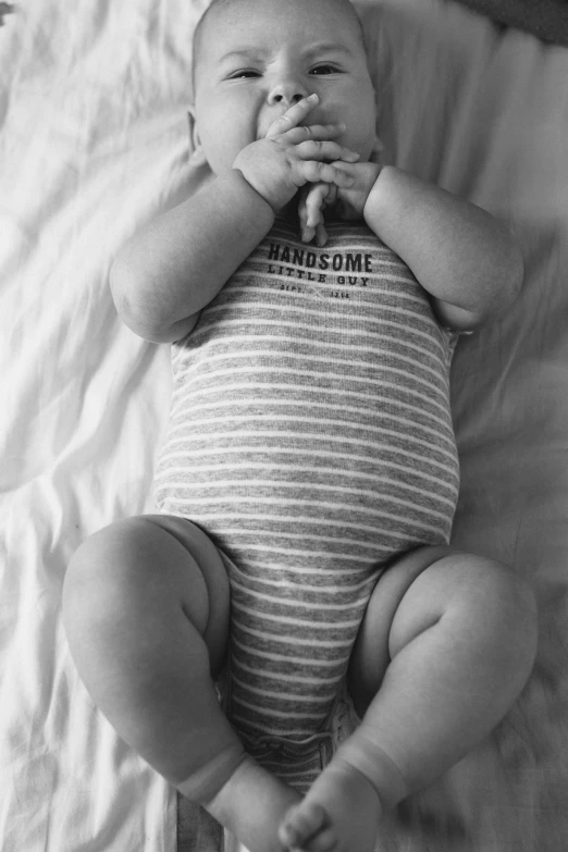 a black and white photo of a baby, by Dan Frazier, pexels contest winner, renaissance, diaper-shaped, striped, dressed casually, bloated