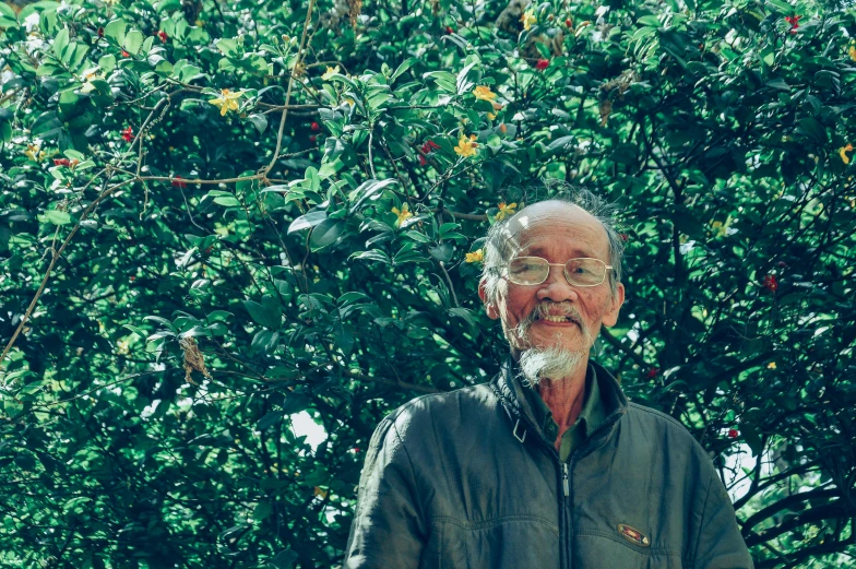 an older man standing in front of a tree, a portrait, unsplash, shin hanga, with fruit trees, avatar image, nothofagus, song nan li